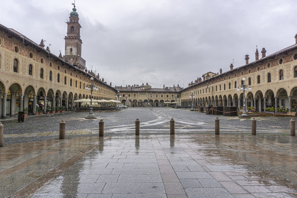 a large courtyard with a clock tower in the background