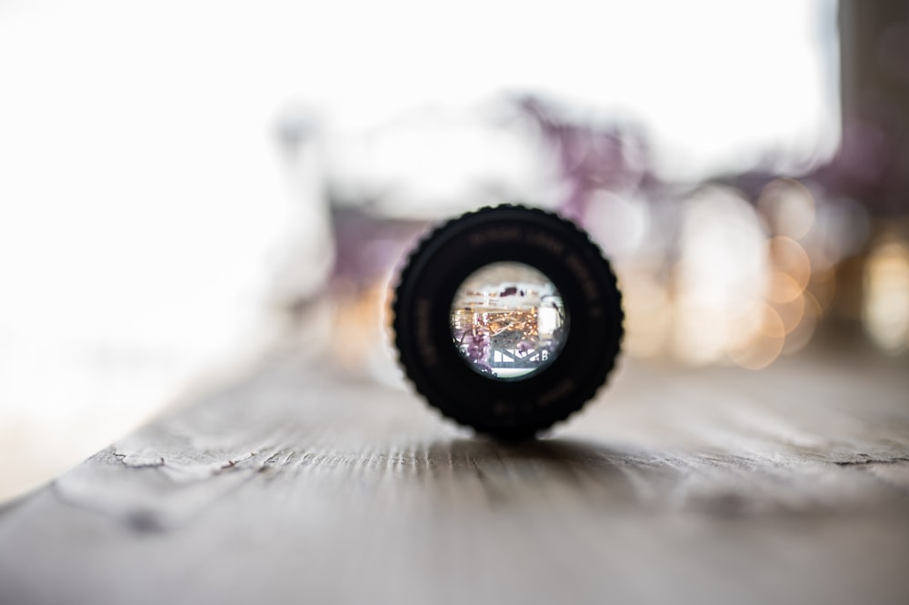 a camera lens sitting on top of a wooden table