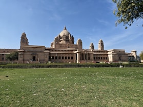 a large building with a large lawn in front of it
