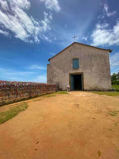 a small church with a cross on top of it