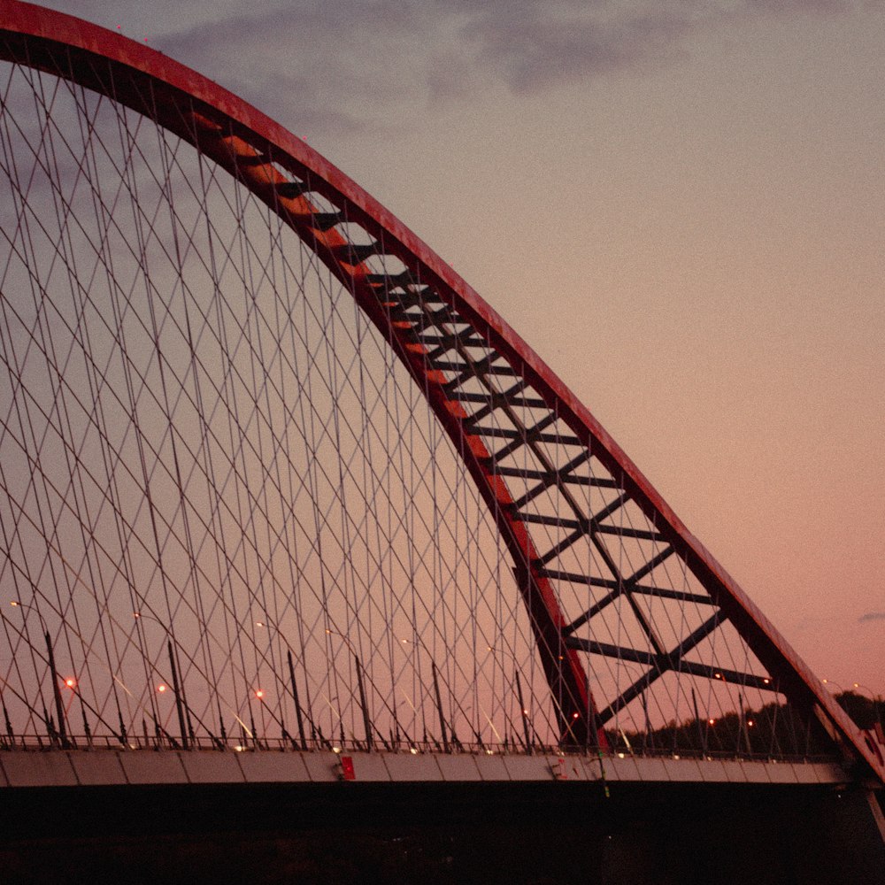 a bridge that has a plane flying over it