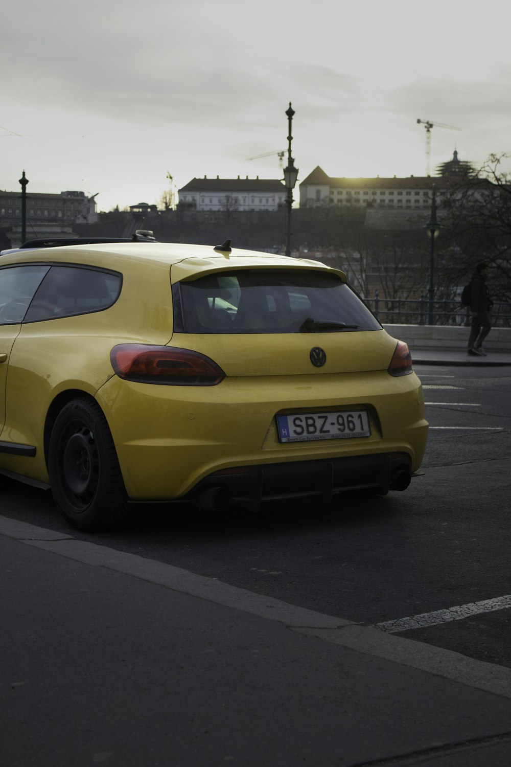 a yellow car is parked in a parking lot