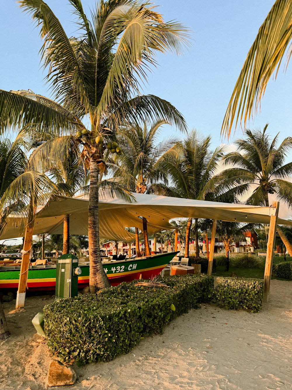 a row of boats sitting on top of a sandy beach