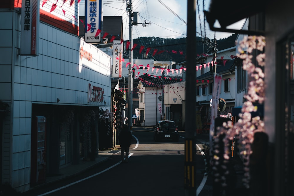 a person walking down a street in a small town