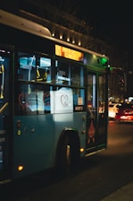 a city bus driving down a street at night