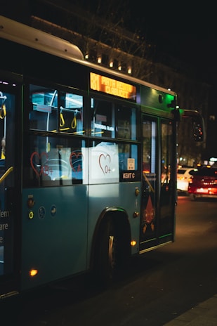 a city bus driving down a street at night
