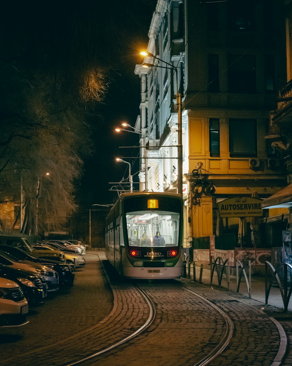 a city bus on a city street at night