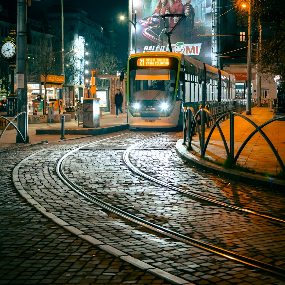 a city bus driving down a street at night