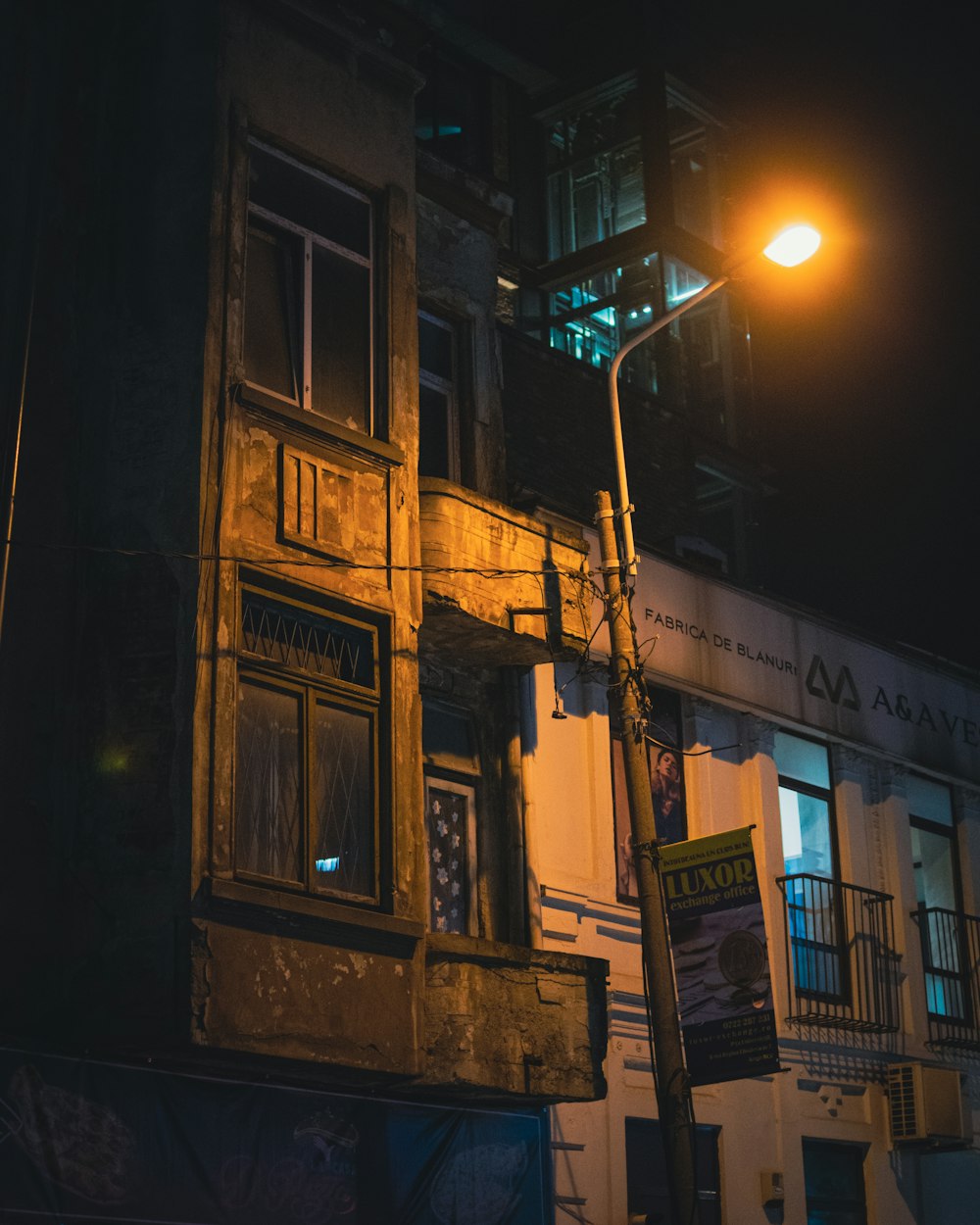 an old building with a street light in front of it