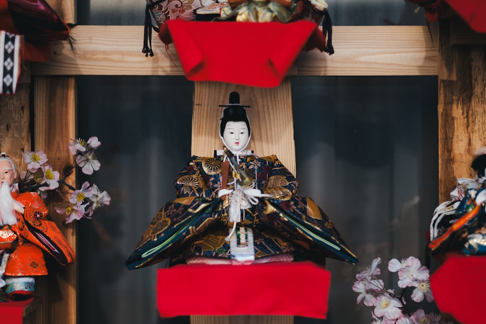 a group of asian dolls on display in a room