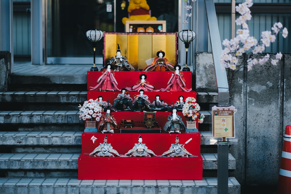 a set of red steps with figurines on them