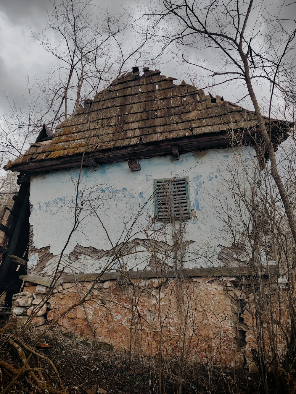 an old run down building with a broken window