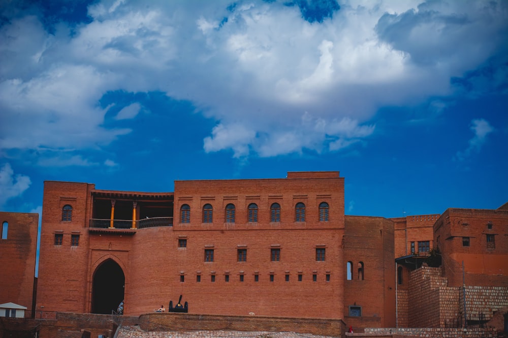 a large brick building with a sky background