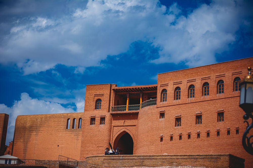 a large brick building with a sky background