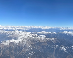 a view of snow covered mountains from an airplane