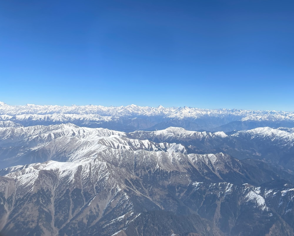 a view of snow covered mountains from an airplane