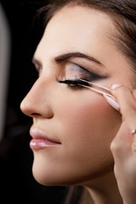 a woman is putting on some makeup