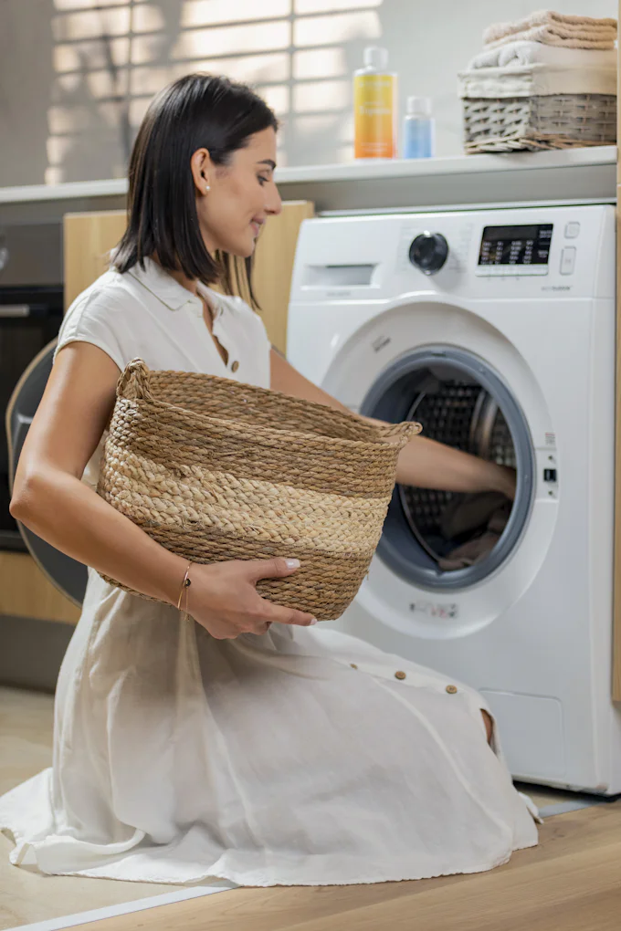 Homeowner doing laundry near a washer and dryer set in Ocoee, FL