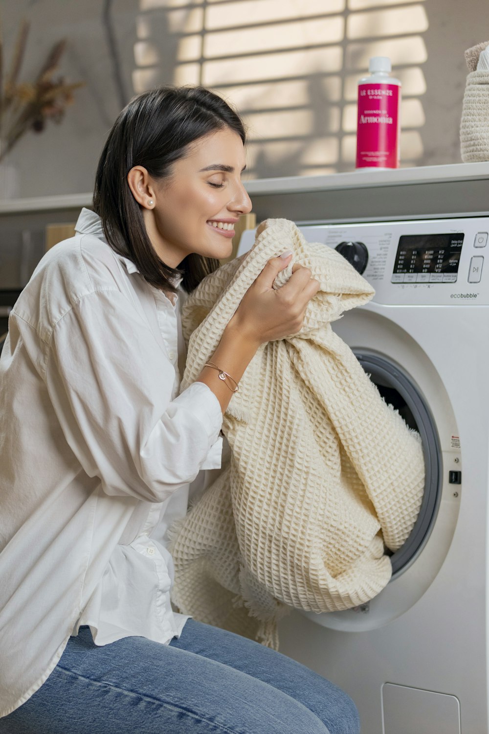 a woman is sitting on a washing machine