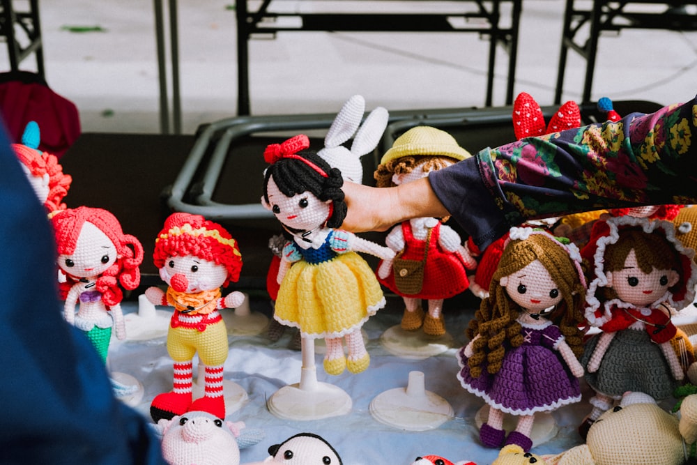 a group of dolls sitting on top of a table