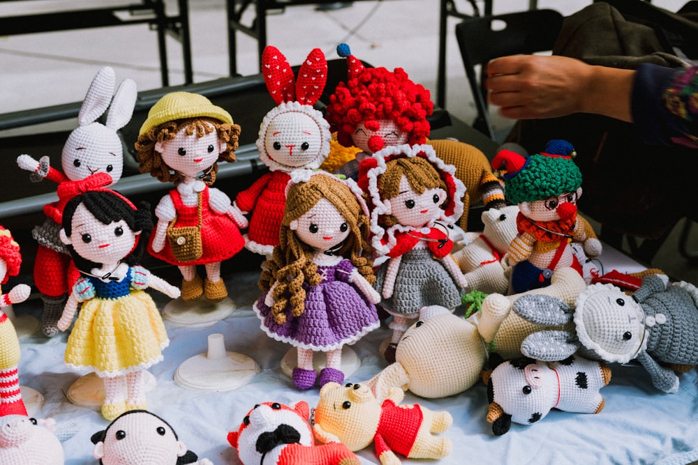 a group of knitted dolls sitting on top of a table