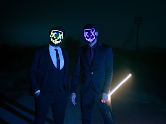 two men in suits and masks standing next to each other