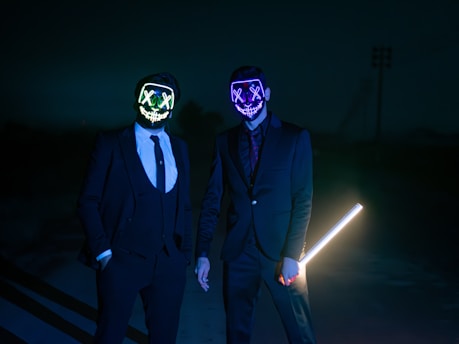 Two men wearing unusual, slightly creepy masks  symbolizng hidden fees and subscription scams in 