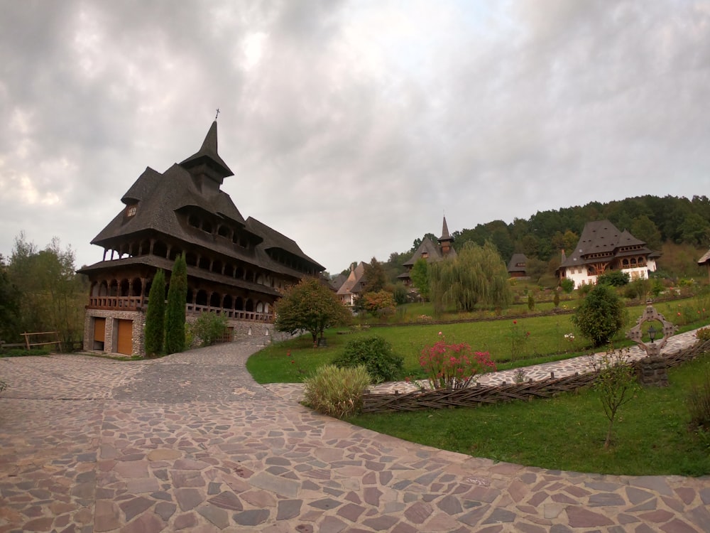 a stone path leads to a building with a thatched roof