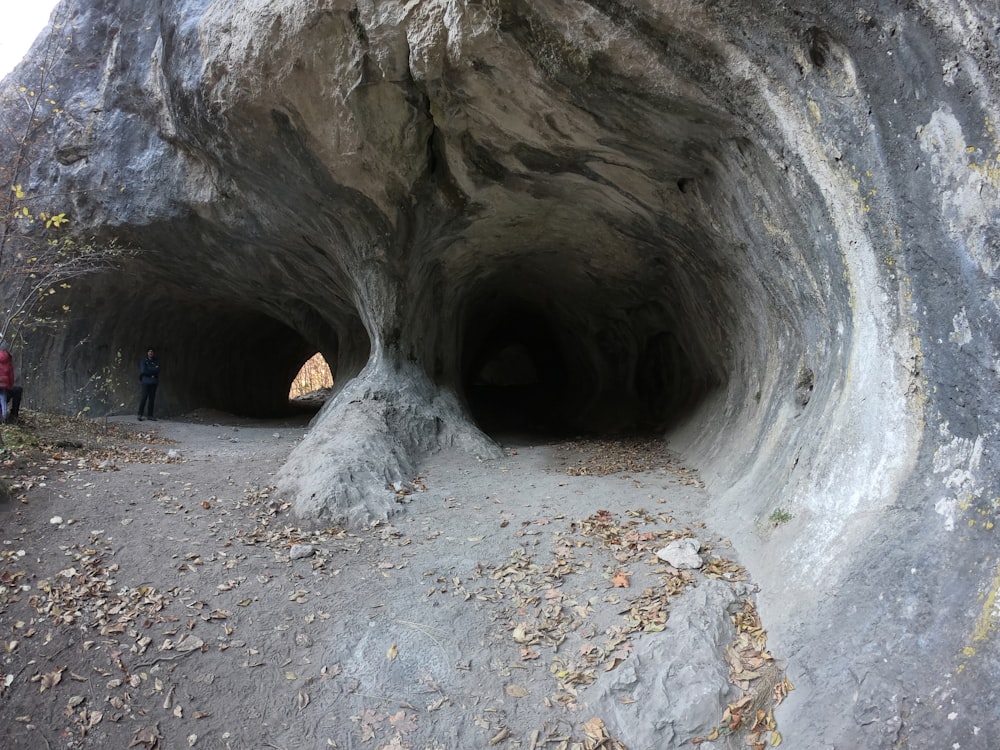 a group of people standing inside of a cave