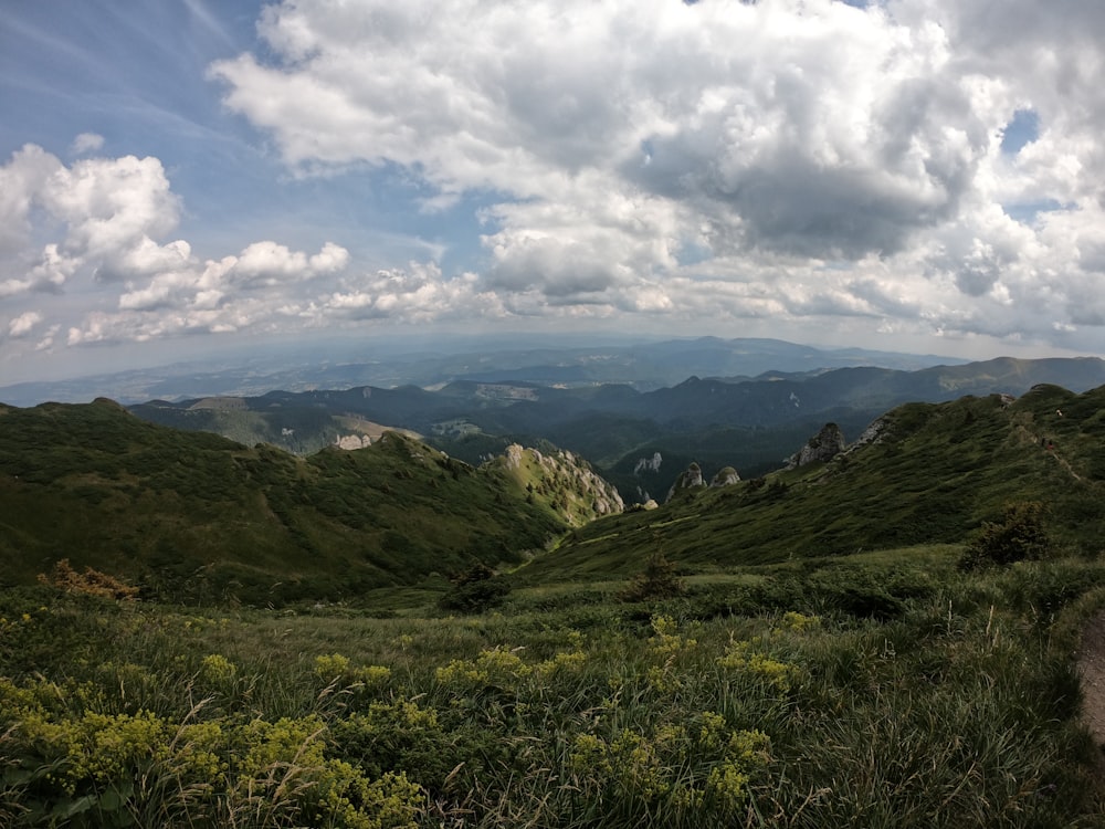 a view of a mountain range with clouds in the sky