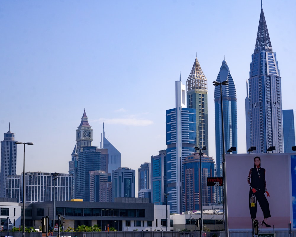 a billboard with a man on it in front of a city