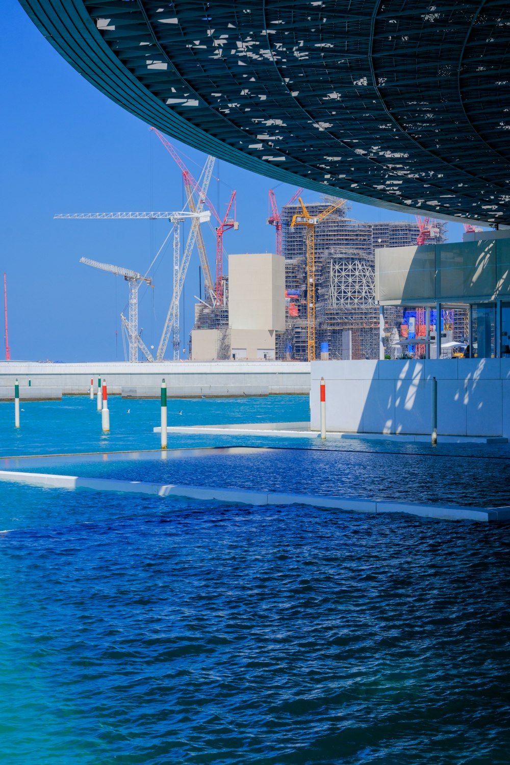 a body of water with construction in the background