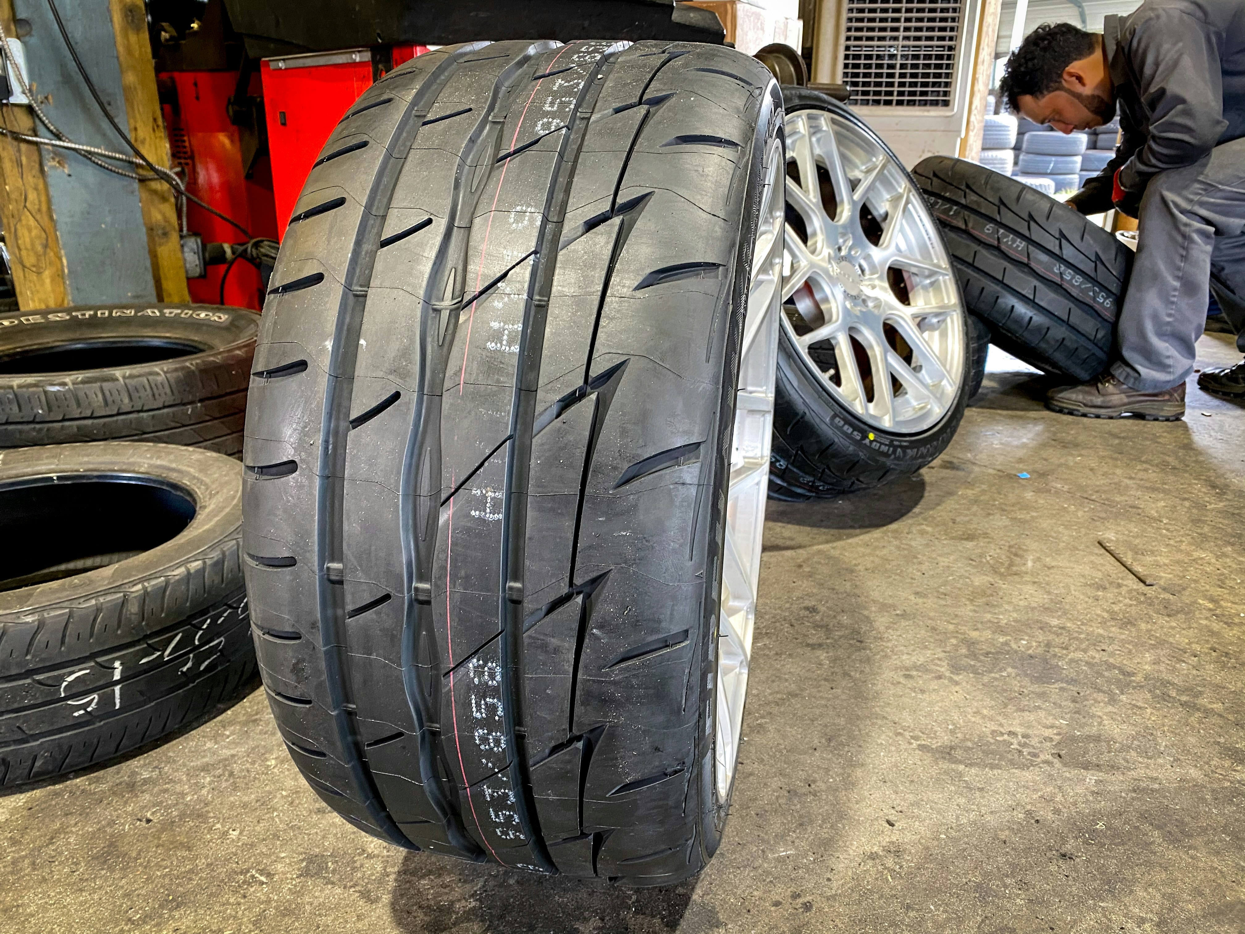 Luxury vehicle wheel and tire close-up, chrome alloy rim, performance automotive detail