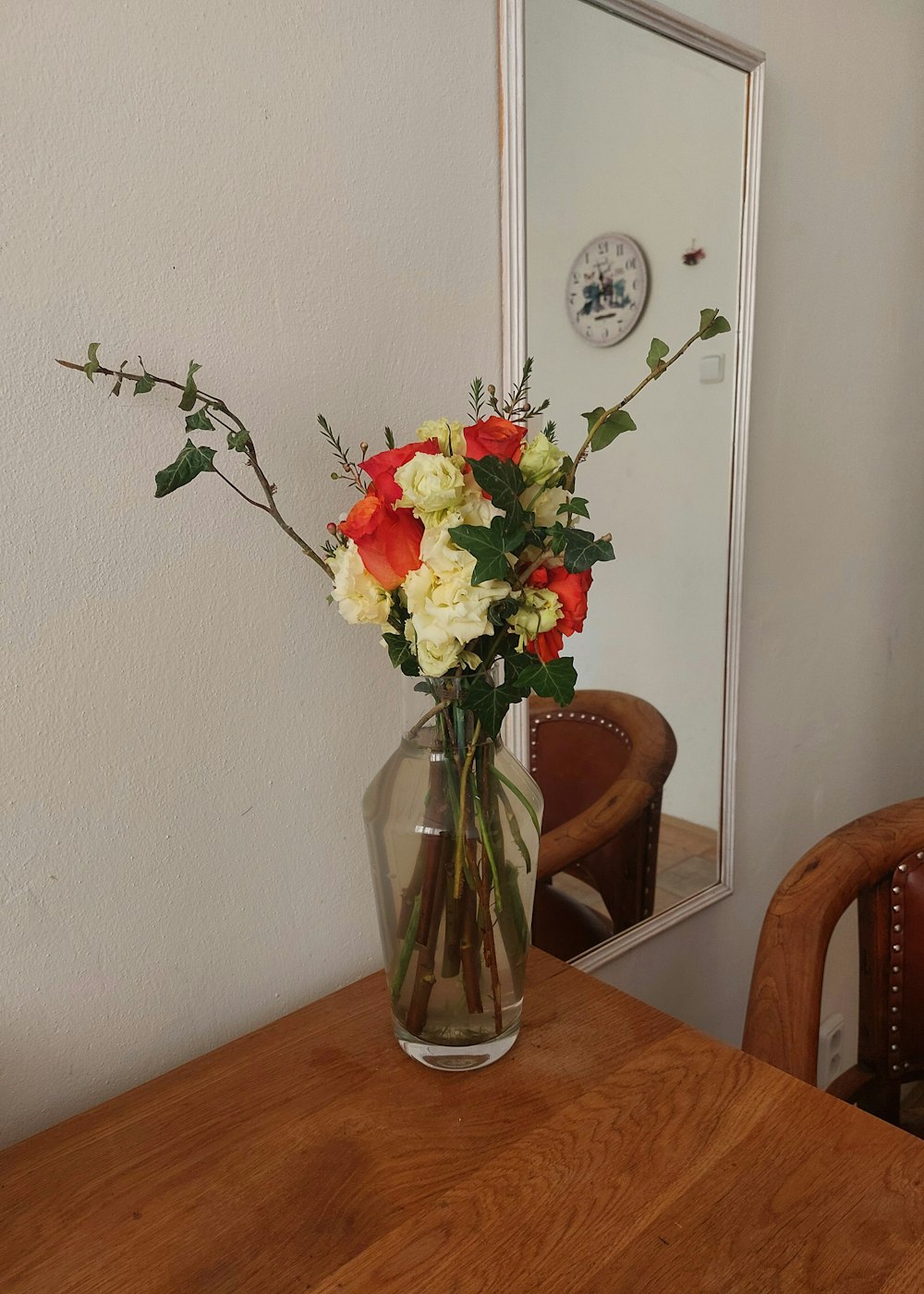 a vase filled with flowers on top of a wooden table