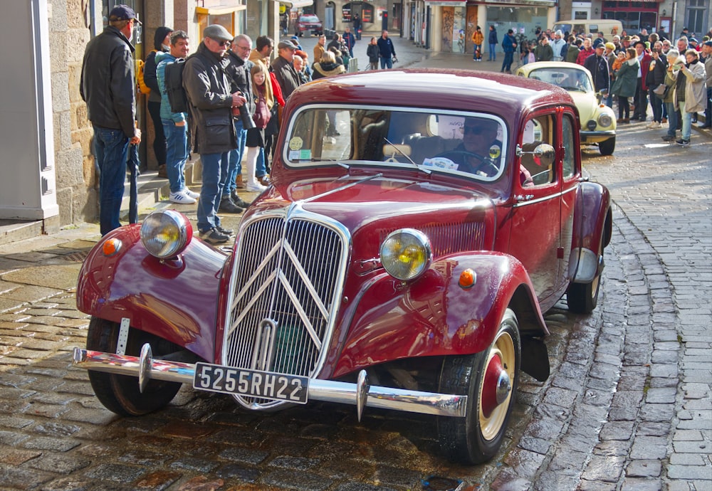 a red car parked on the side of a street