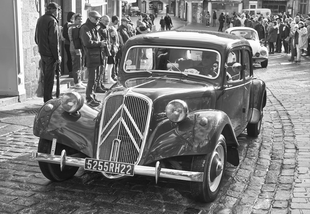 a black and white photo of a vintage car