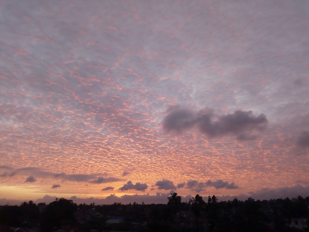 a view of a sunset with clouds in the sky