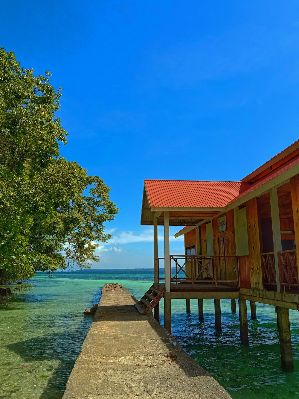 a long dock leading to a row of houses