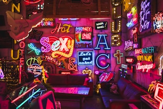 a room filled with neon signs and furniture