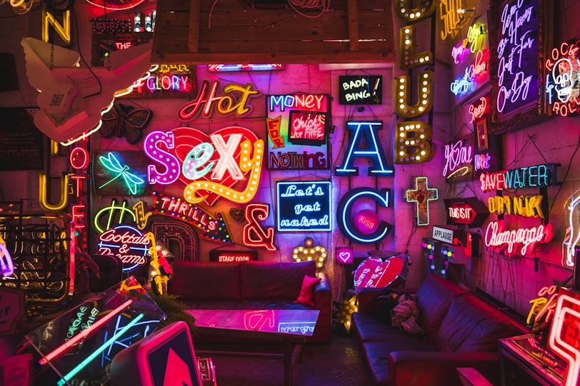 a room filled with neon signs and furniture
