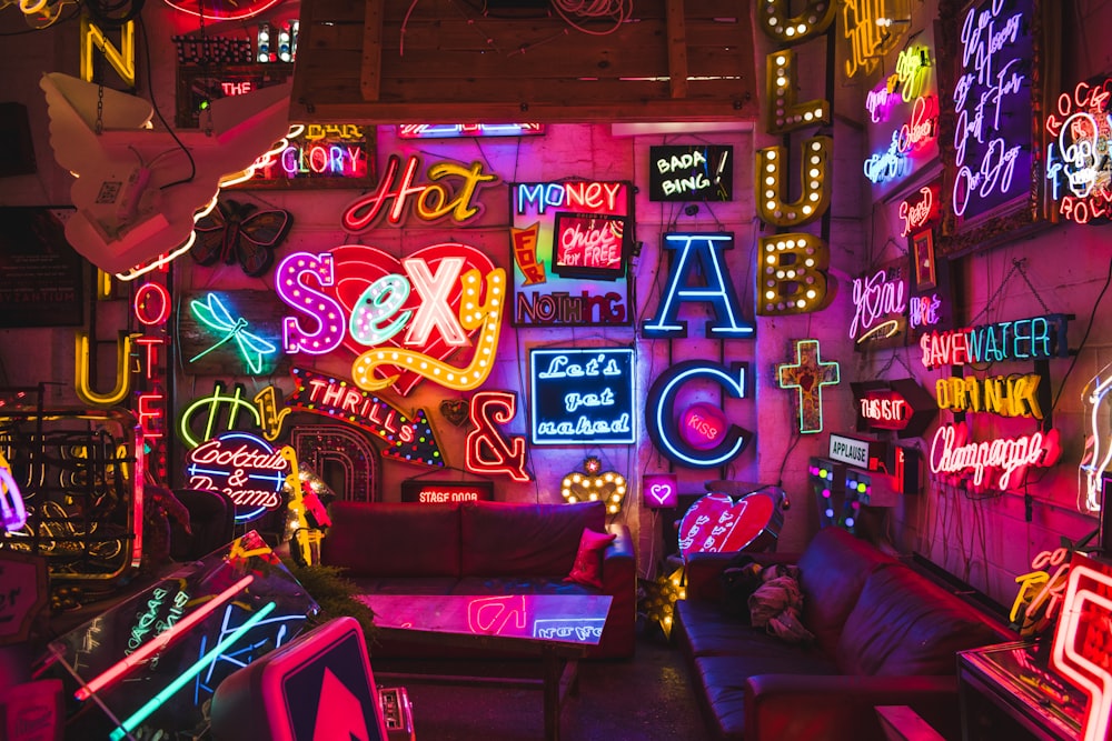 a room filled with neon signs and furniture