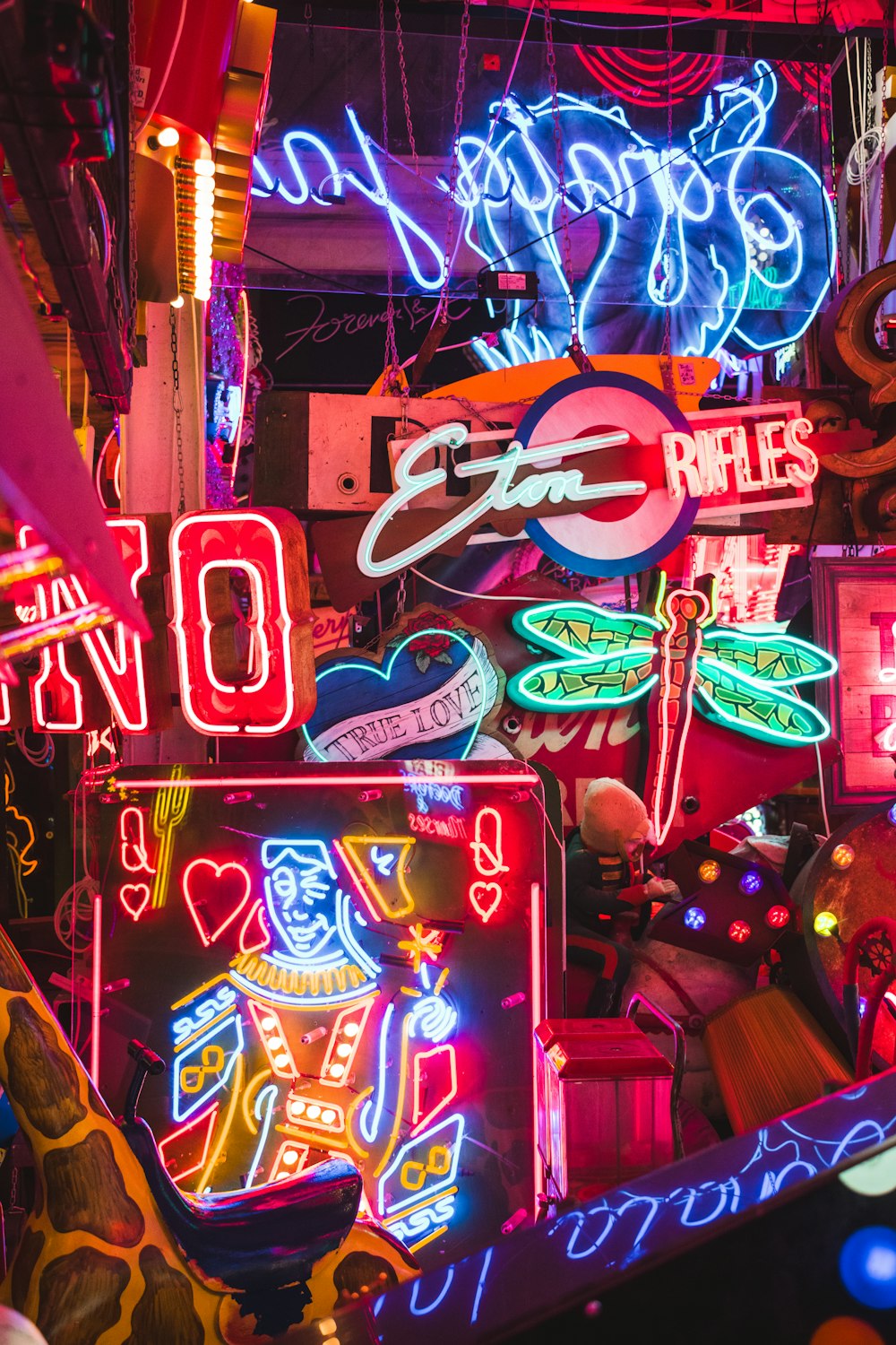 many neon signs are hanging from the ceiling