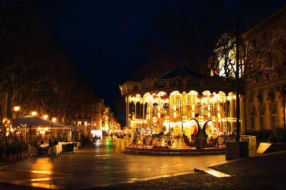 a merry go round in the middle of a city at night