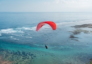 a person para sailing in the ocean on a sunny day