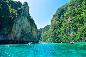 a group of boats floating on top of a body of water