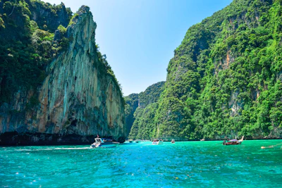 a group of boats floating on top of a body of water