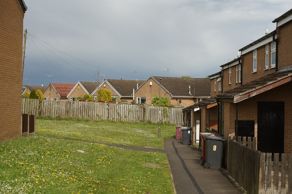 a row of houses next to a wooden fence
