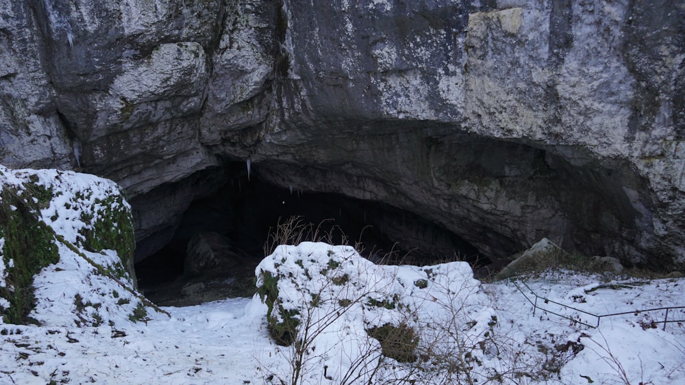a snow covered area with a cave entrance