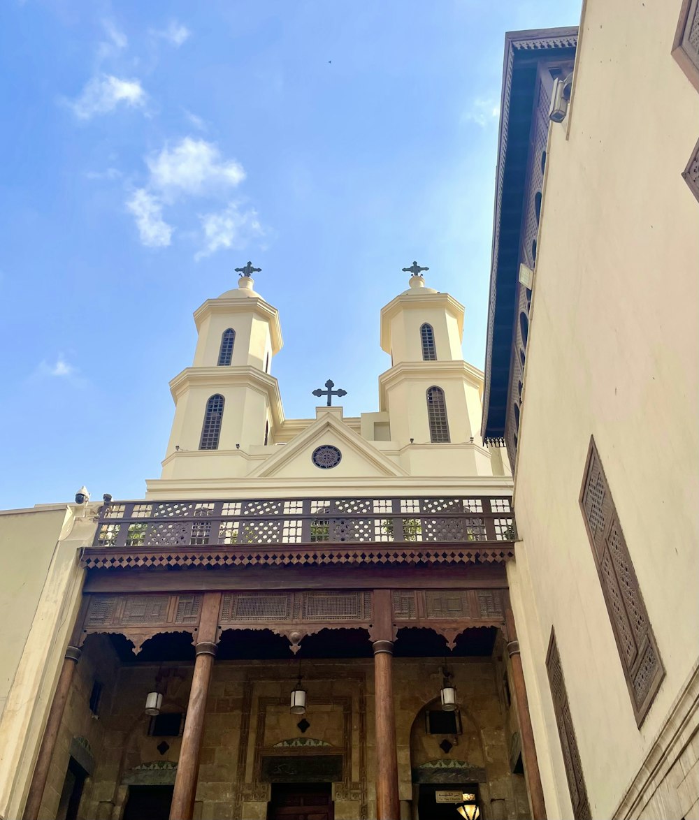 a large building with two towers and a cross on top