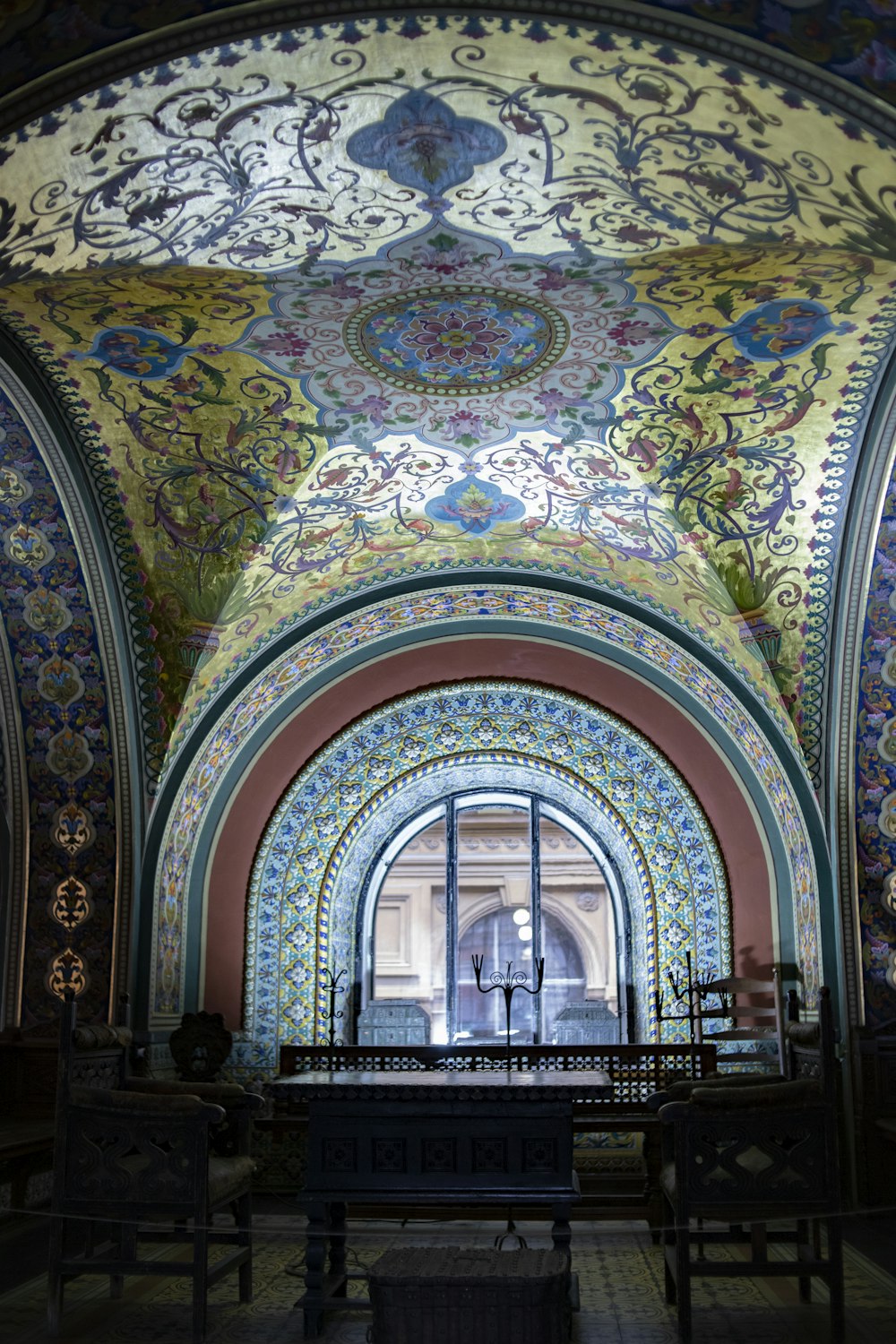 a church with a painted ceiling and stained glass windows